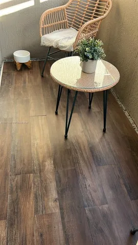 a view of a chairs and table in the balcony
