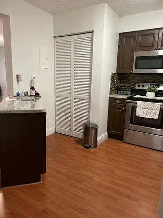 a kitchen with stainless steel appliances granite countertop a stove sink and cabinets