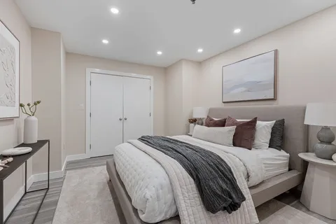 a spacious bedroom with a bed and a painting