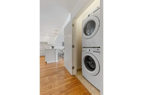 a view of a kitchen with a washer and dryer