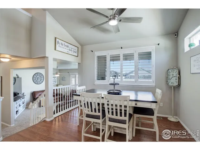 a view of a dining room with furniture and a window