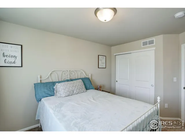 a bedroom with a bed and a night stand