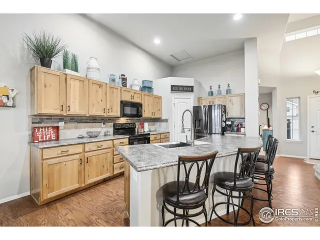 a kitchen with appliances a sink and cabinets