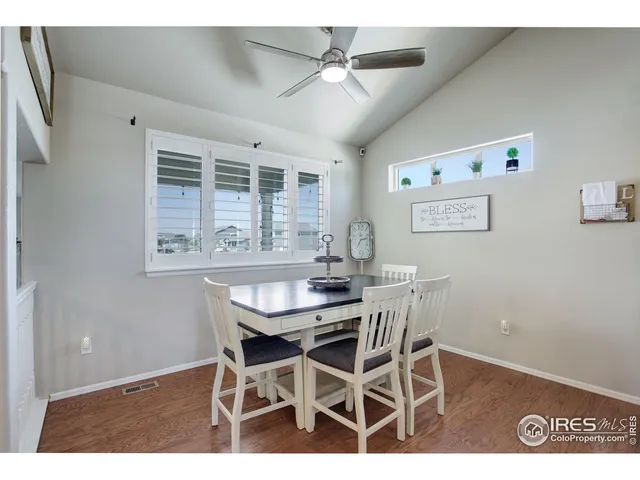 a view of a dining room with furniture and a chandelier