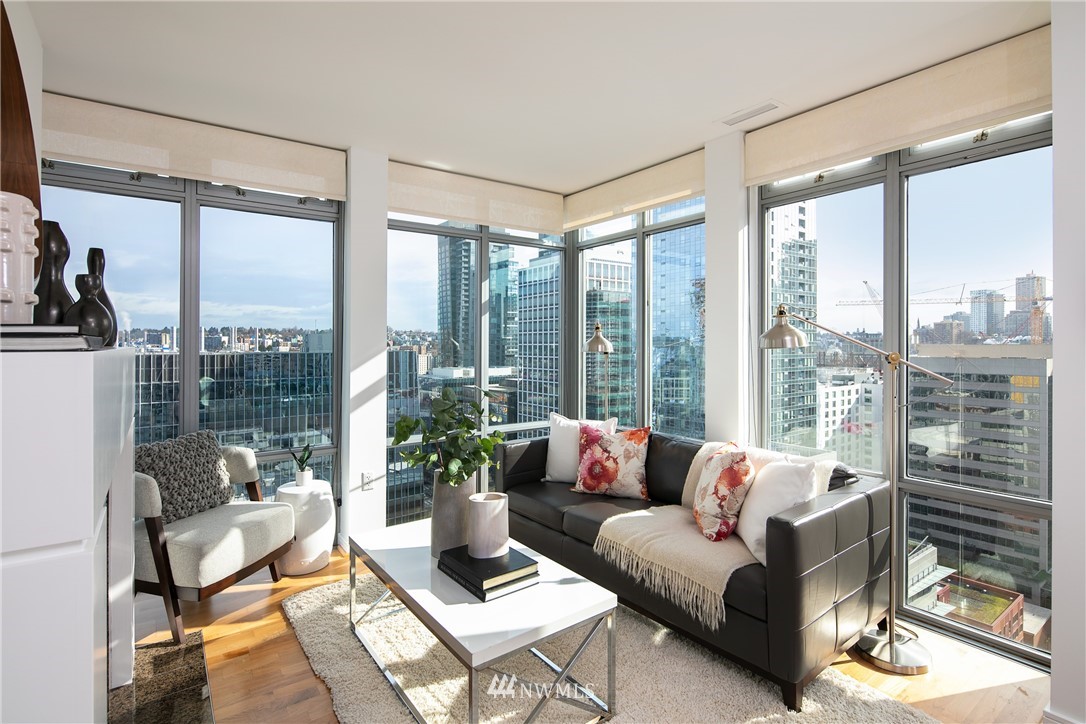 819 Virginia Street, Unit 2804 Seattle, WA 98101 - Photo 2 of 22 a living room with furniture and floor to ceiling windows