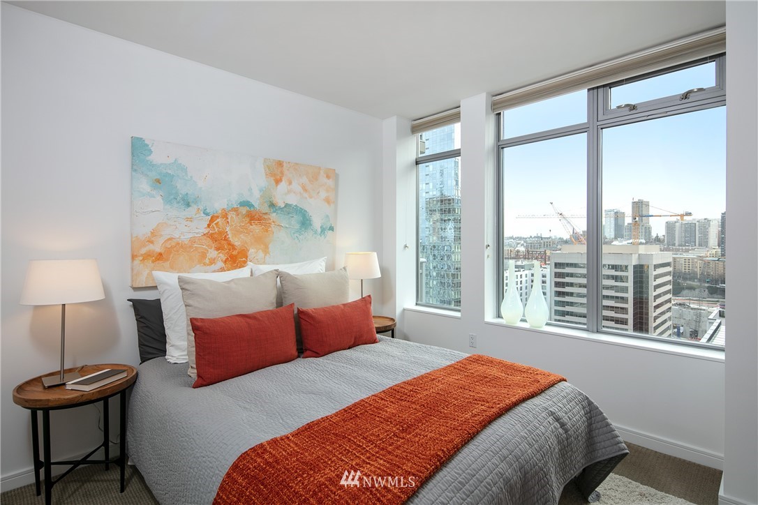 819 Virginia Street, Unit 2804 Seattle, WA 98101 - Photo 11 of 22 a bedroom with a bed and a lamp next to a window