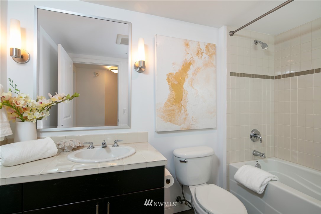 819 Virginia Street, Unit 2804 Seattle, WA 98101 - Photo 12 of 22 a bathroom with a sink toilet and shower