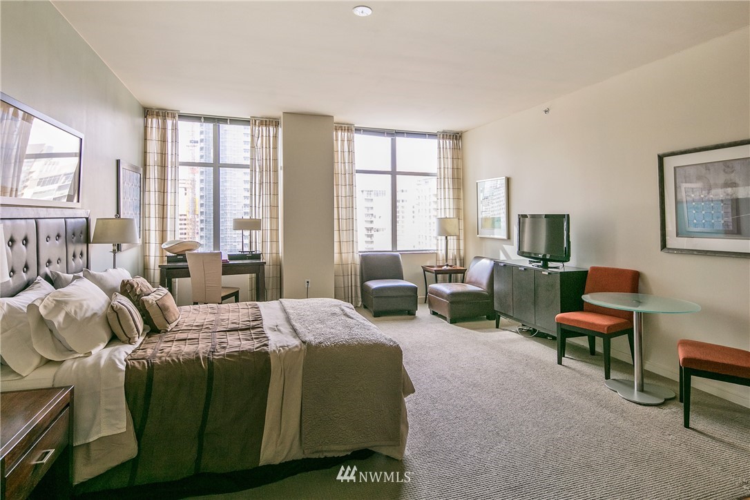 819 Virginia Street, Unit 2804 Seattle, WA 98101 - Photo 20 of 22 a bedroom with a bed a large window and a couch