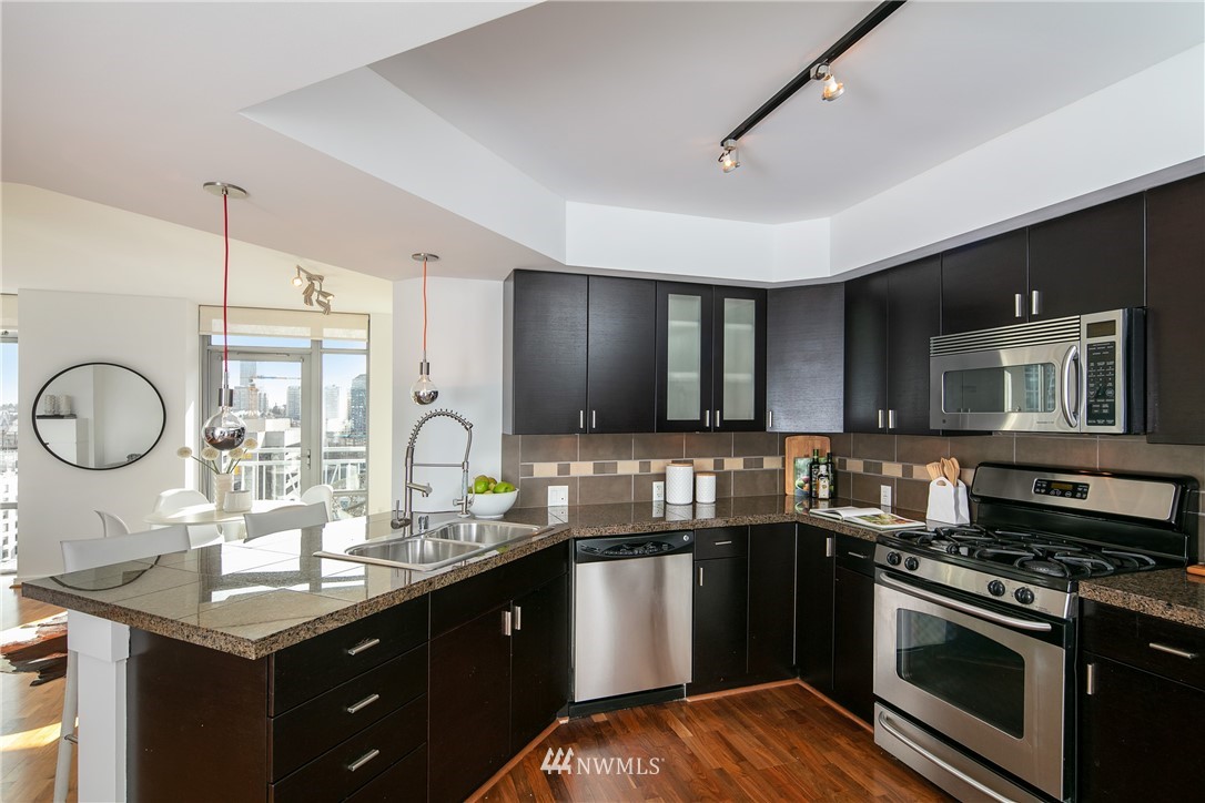 819 Virginia Street, Unit 2804 Seattle, WA 98101 - Photo 4 of 22 a kitchen with a sink stove and cabinets
