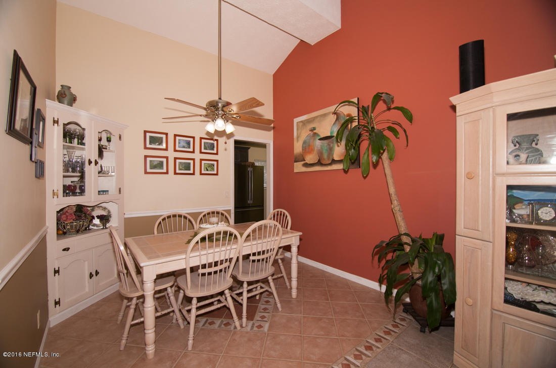 12594 Agatite Road Jacksonville, FL 32258 - Photo 12 of 49 a dining room with furniture and a potted plant