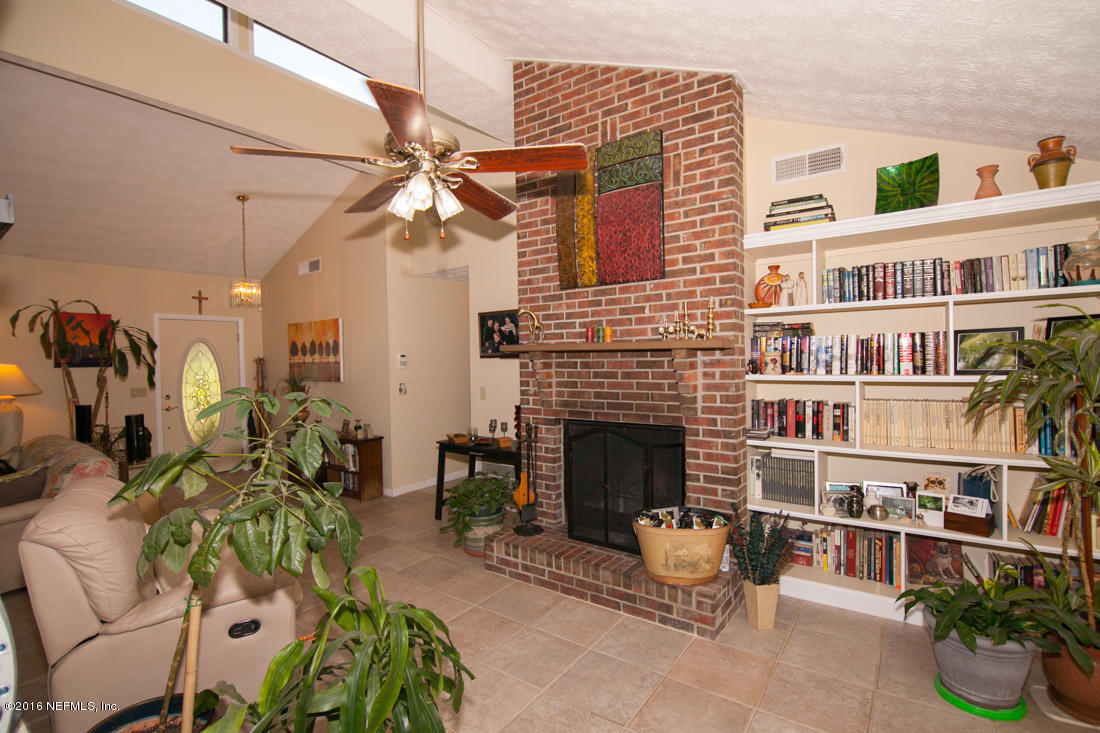 12594 Agatite Road Jacksonville, FL 32258 - Photo 14 of 49 a living room with furniture fireplace and decor