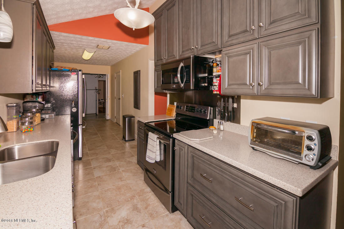 12594 Agatite Road Jacksonville, FL 32258 - Photo 18 of 49 a kitchen with stainless steel appliances granite countertop a stove and a sink