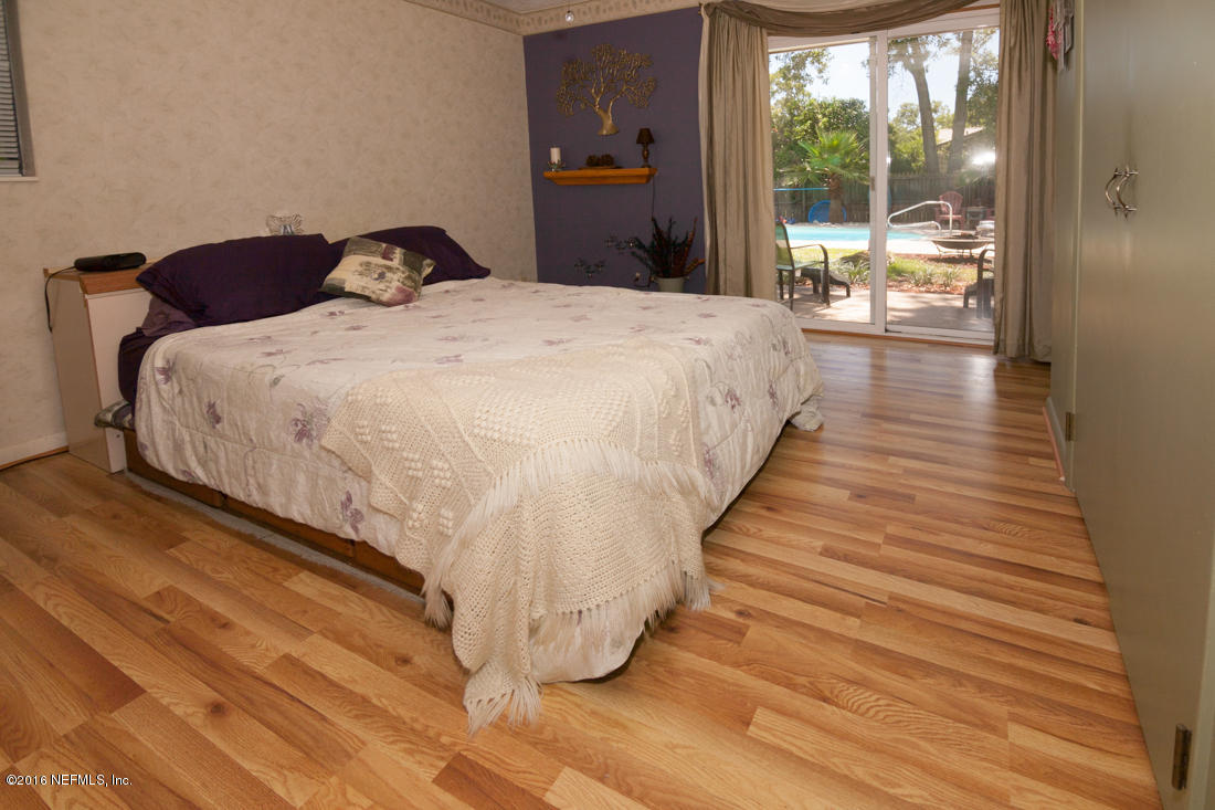 12594 Agatite Road Jacksonville, FL 32258 - Photo 21 of 49 a large bed sitting in a bedroom next to a window