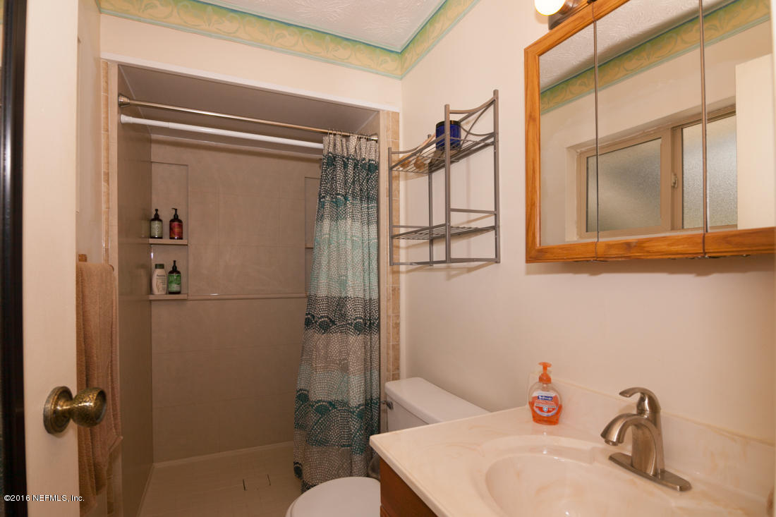 12594 Agatite Road Jacksonville, FL 32258 - Photo 23 of 49 a bathroom with a sink toilet and shower