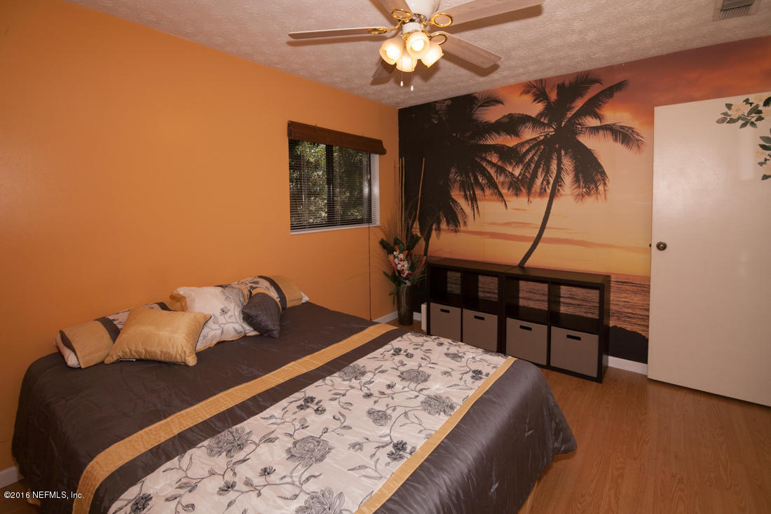 12594 Agatite Road Jacksonville, FL 32258 - Photo 27 of 49 a bed sitting in a bedroom next to a window