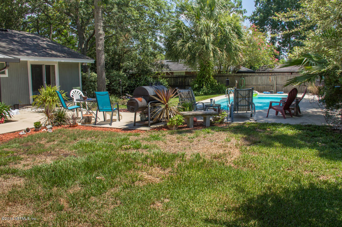 12594 Agatite Road Jacksonville, FL 32258 - Photo 45 of 49 a view of a chair and table in backyard of the house