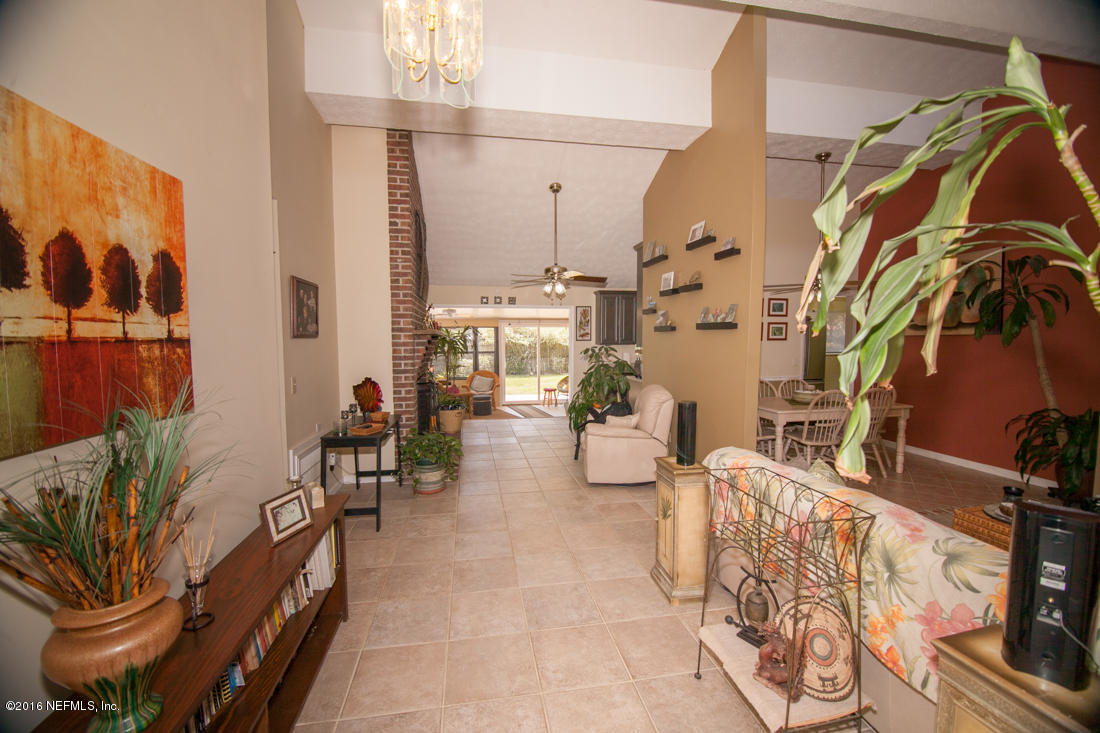 12594 Agatite Road Jacksonville, FL 32258 - Photo 8 of 49 a living room with patio furniture and a painting on the wall