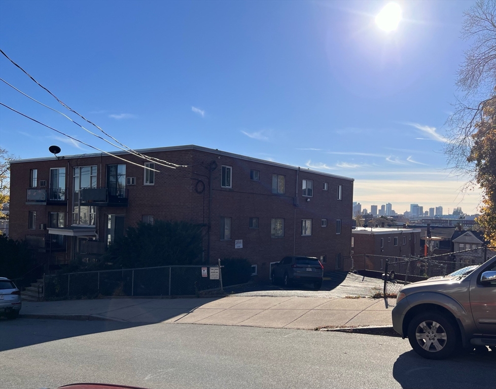 215 Washington Avenue, Unit 9 Chelsea, MA 02150 - Photo 1 of 16 a car parked in front of a building