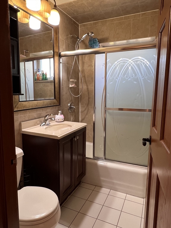 215 Washington Avenue, Unit 9 Chelsea, MA 02150 - Photo 11 of 16 a bathroom with a sink vanity mirror and toilet