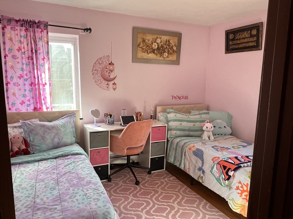 215 Washington Avenue, Unit 9 Chelsea, MA 02150 - Photo 8 of 16 a bedroom with a bed and wooden floor
