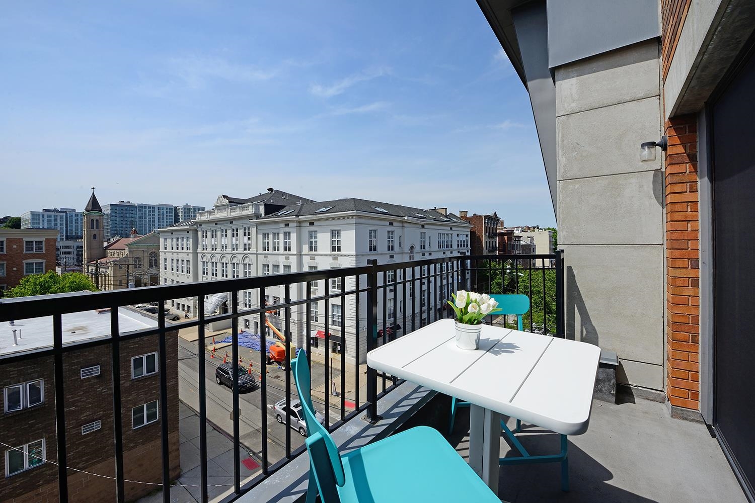 a balcony with a table and chairs