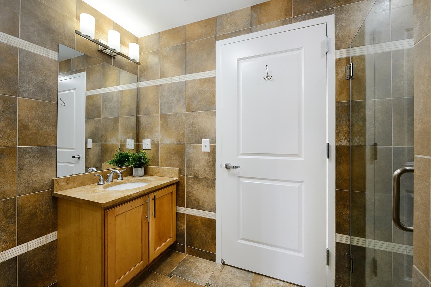 619 Adams Street, Unit 509 Hoboken, NJ 07030 - Photo 19 of 29 a bathroom with a sink mirror and shower
