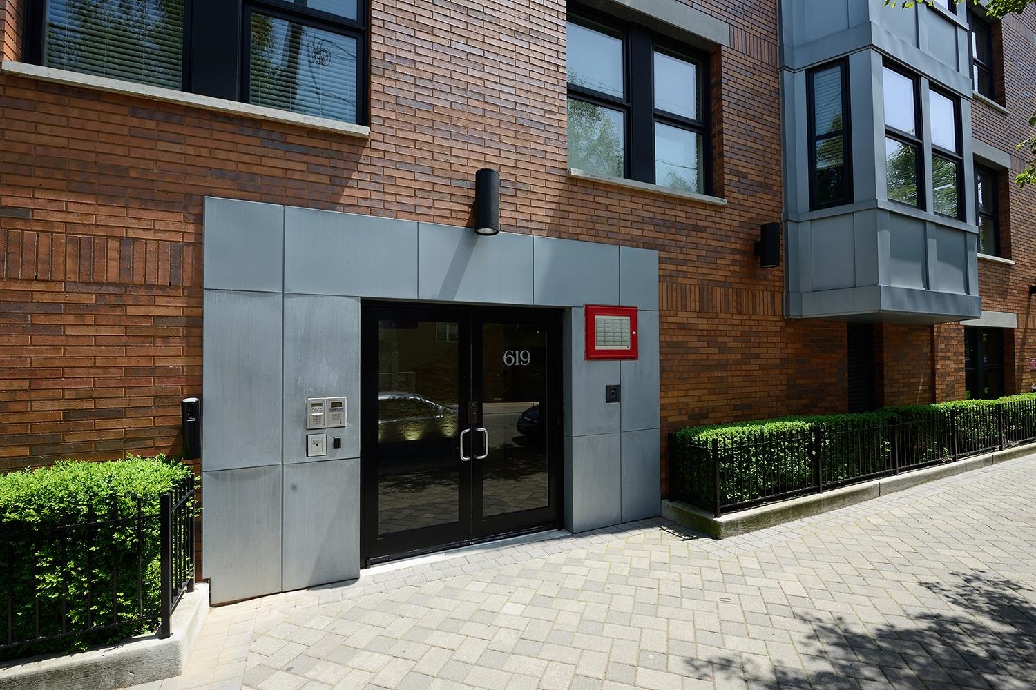 619 Adams Street, Unit 509 Hoboken, NJ 07030 - Photo 22 of 29 a view of a brick house with a yard and garage