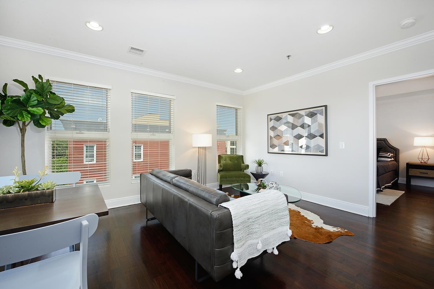 619 Adams Street, Unit 509 Hoboken, NJ 07030 - Photo 8 of 29 a living room with furniture potted plant and a window