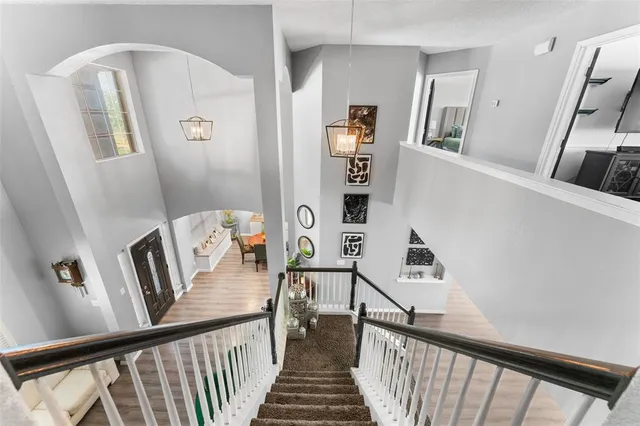 a view of a hallway with windows and stairs