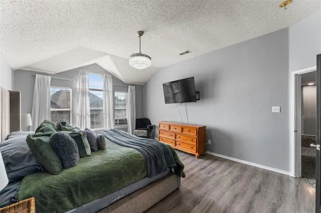 a bedroom with furniture and a flat screen tv
