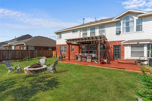 a front view of a house with a garden and patio
