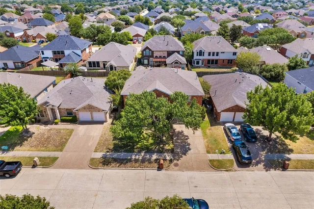 an aerial view of multiple houses with yard