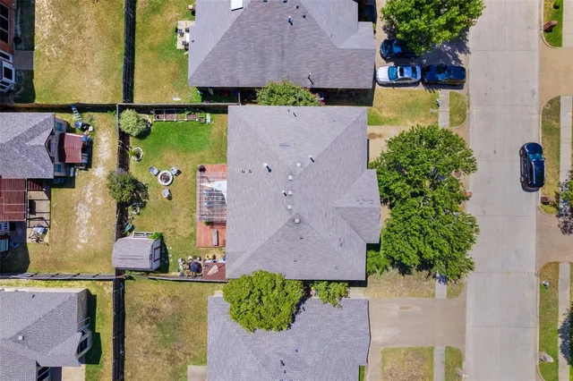 an aerial view of a houses with yard