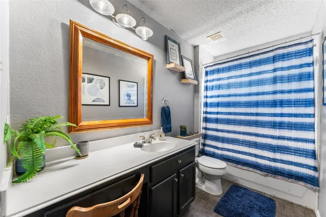 a bathroom with a sink a mirror and a toilet