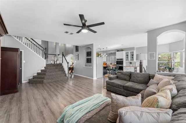 a living room with furniture and a wooden floor