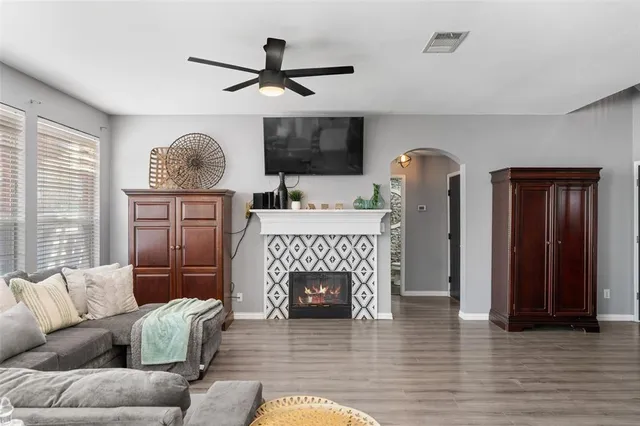 a living room with furniture a window and a fireplace