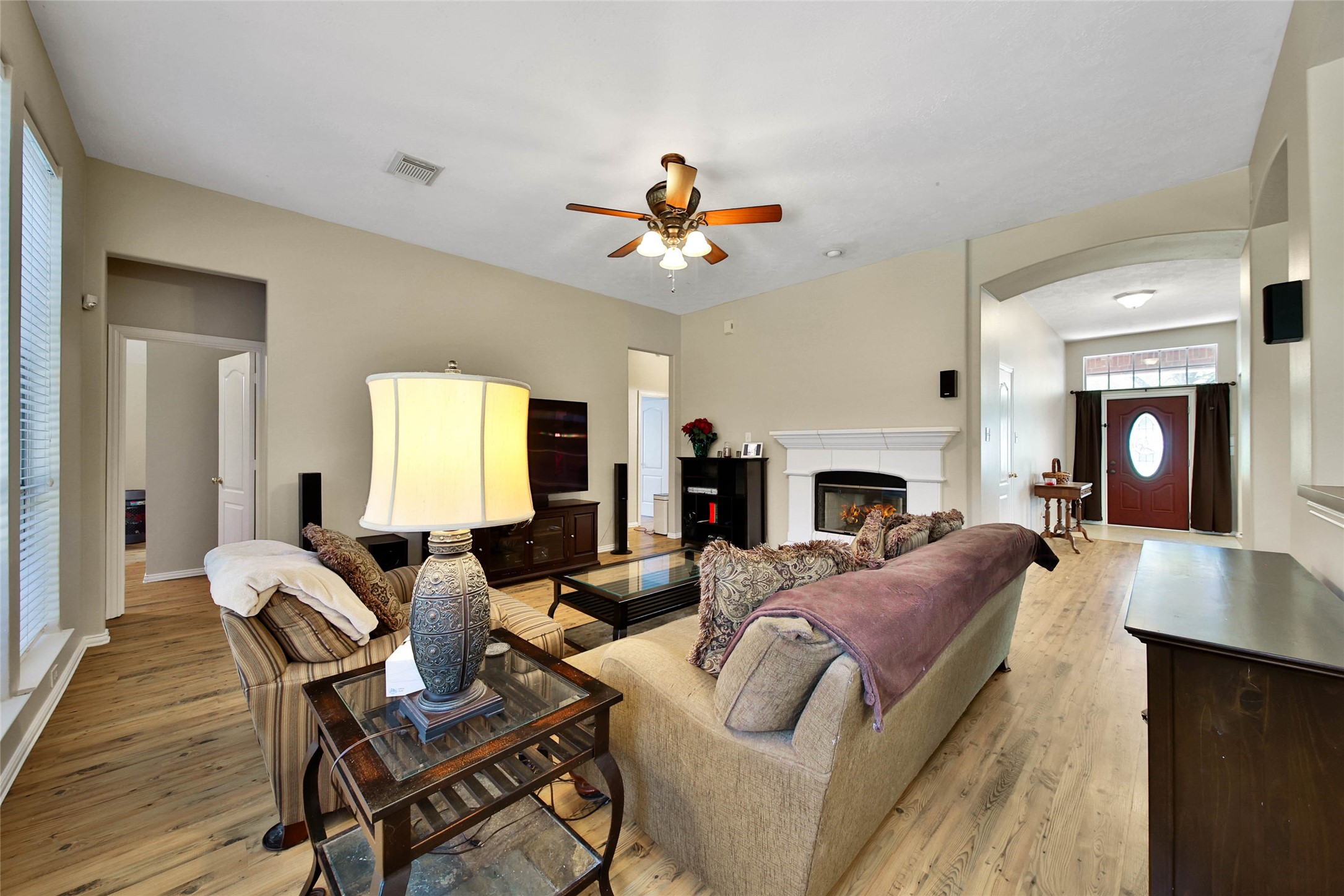 21338 Timber Pines Drive Spring, TX 77388 - Photo 11 of 29 a living room with furniture a fireplace and a chandelier
