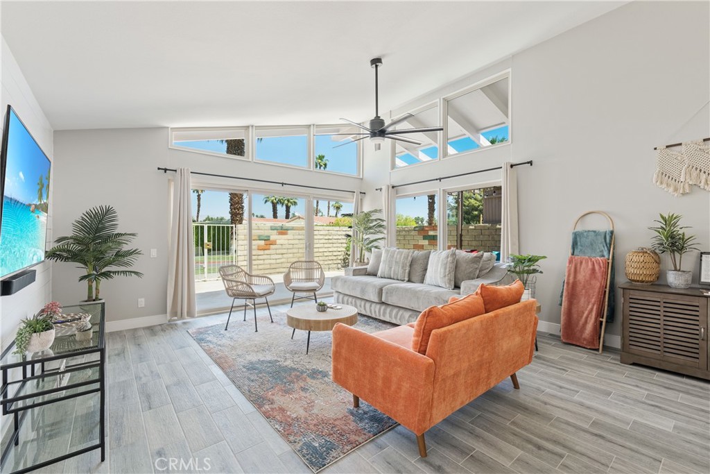 82190 Waring Way Indio, CA 92201 - Photo 1 of 1 a living room with furniture a chandelier and a dining table