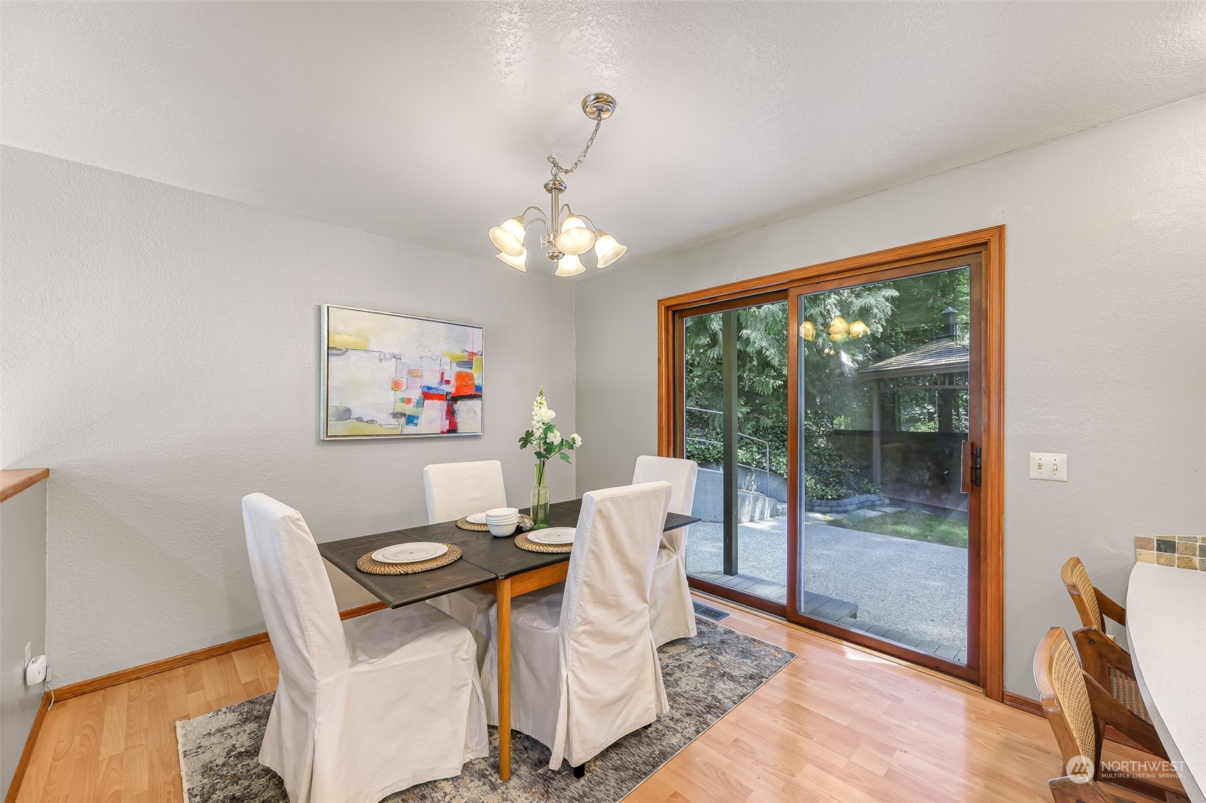 3901 Cabrant Road Everson, WA 98247 - Photo 12 of 40 a workspace with furniture wooden floor and a chandelier
