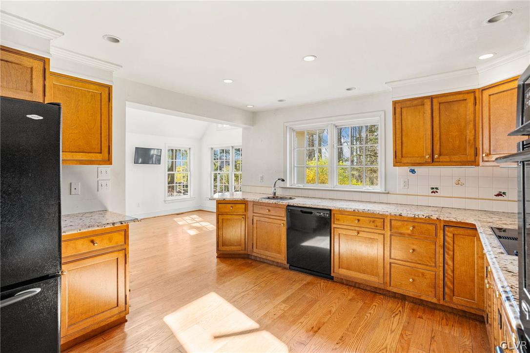 175 Beaumont Road Devon, PA 19333 - Photo 14 of 49 a large kitchen with stainless steel appliances granite countertop a sink and cabinets with wooden floor
