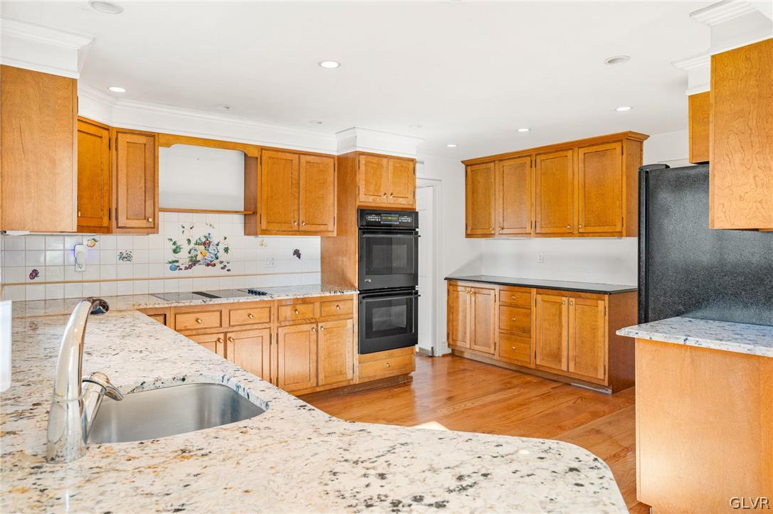 175 Beaumont Road Devon, PA 19333 - Photo 16 of 49 a kitchen with stainless steel appliances kitchen island granite countertop a sink refrigerator and cabinets