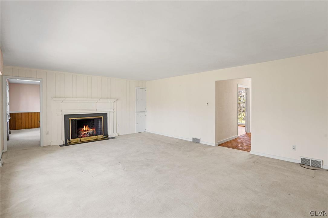 175 Beaumont Road Devon, PA 19333 - Photo 25 of 49 a view of an empty room with a fireplace and a window