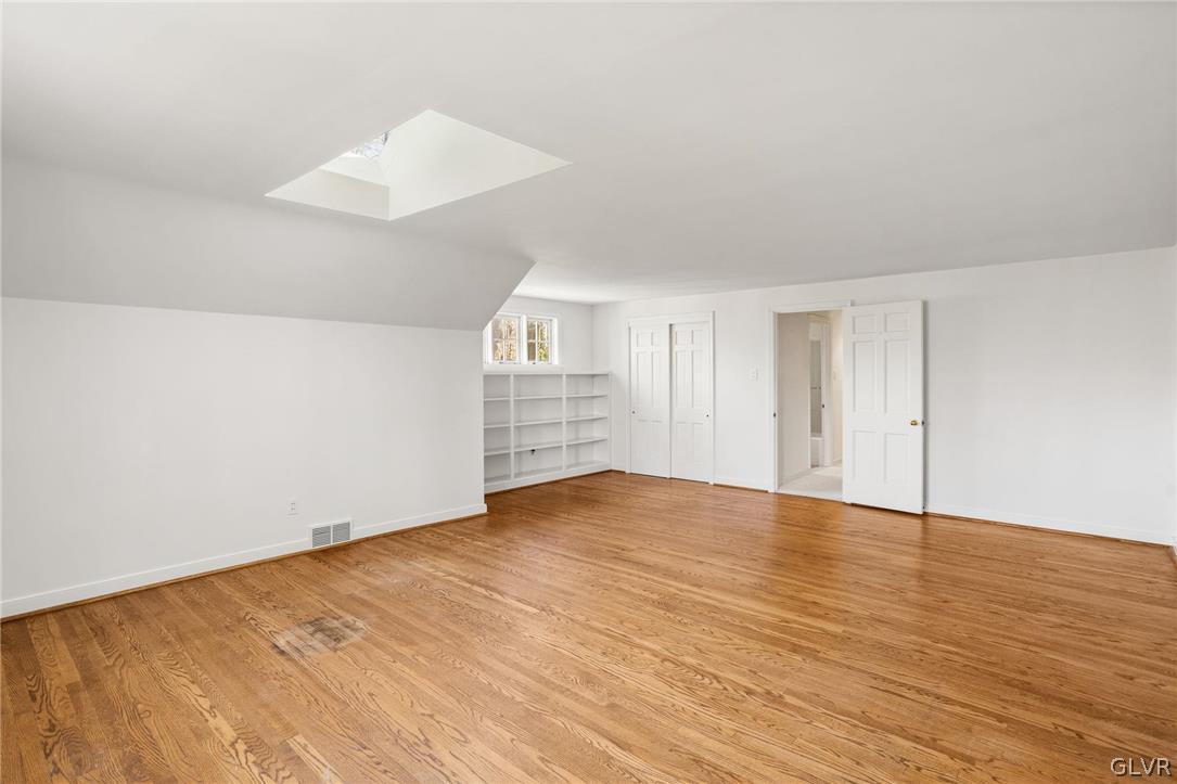 175 Beaumont Road Devon, PA 19333 - Photo 41 of 49 an empty room with wooden floor and windows