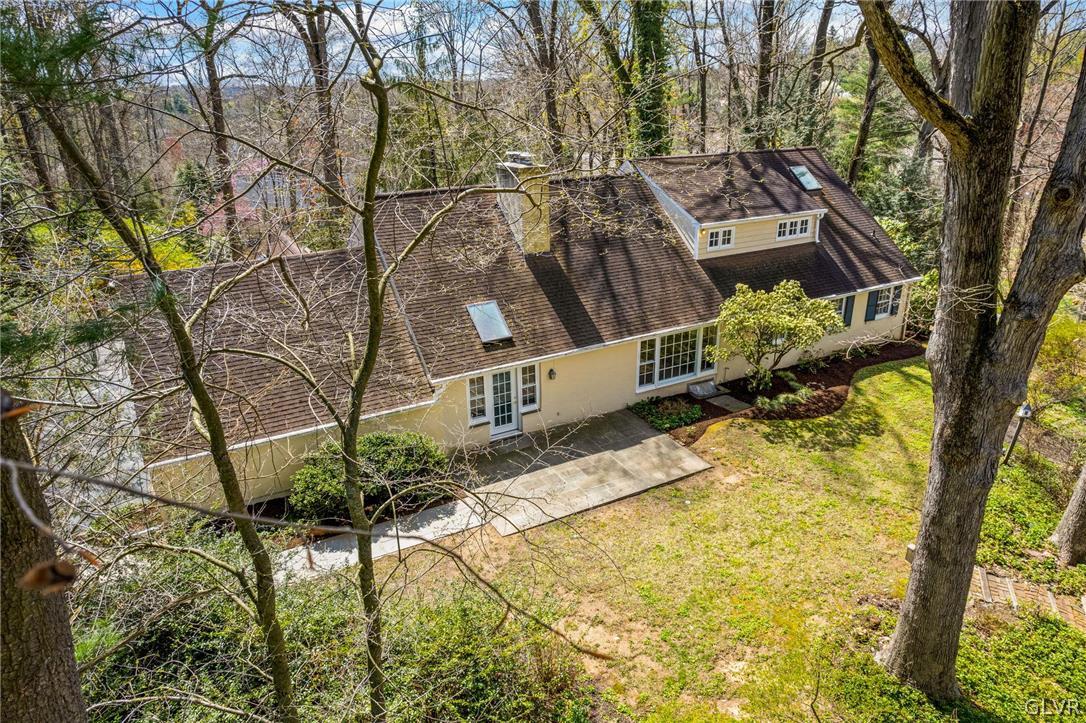 175 Beaumont Road Devon, PA 19333 - Photo 47 of 49 a backyard of a house with large trees and outdoor seating
