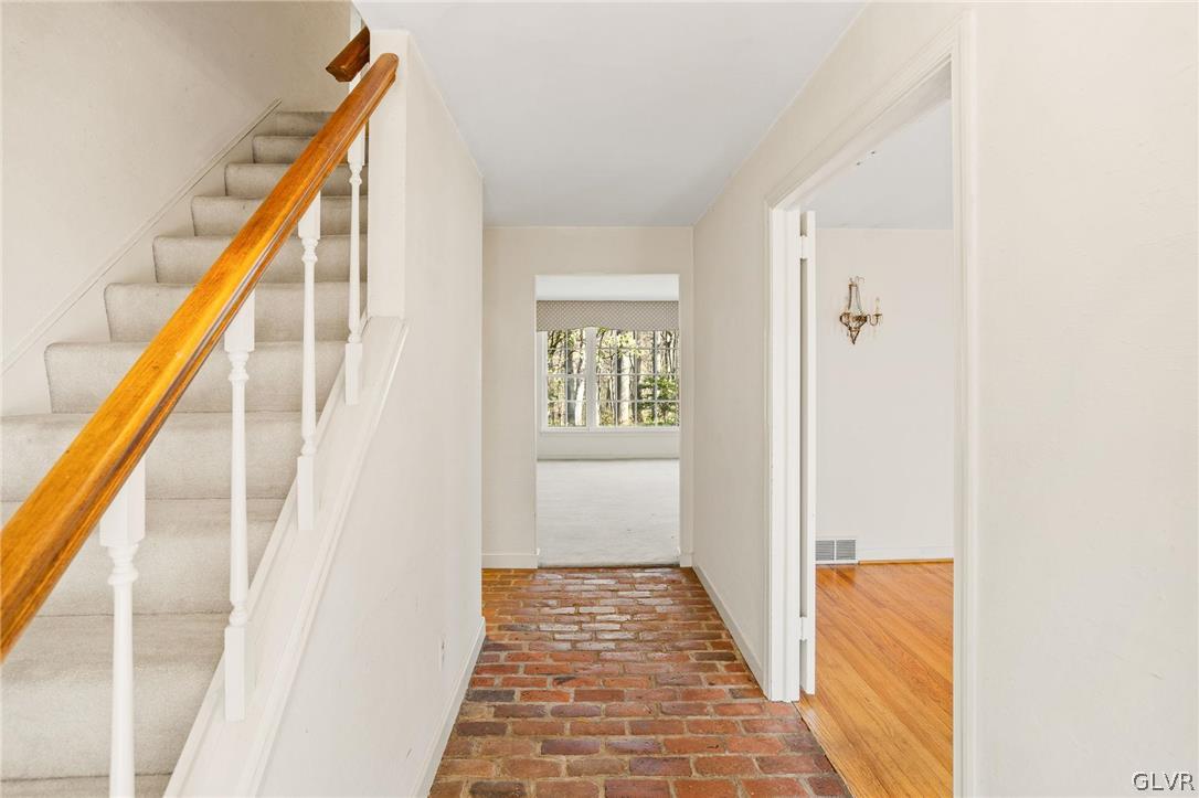 175 Beaumont Road Devon, PA 19333 - Photo 10 of 49 a view of a hallway with wooden floor and staircase