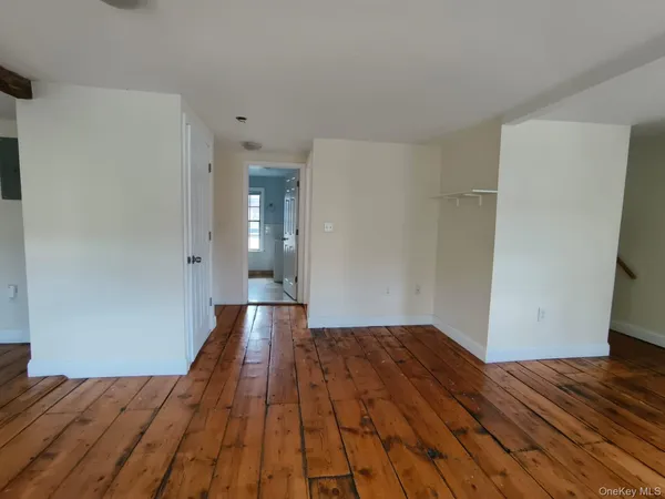 a view of a room with wooden floor