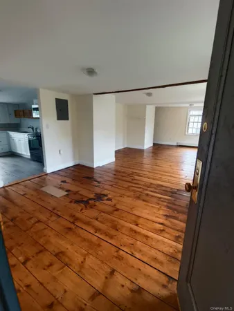 a view of a room with wooden floor