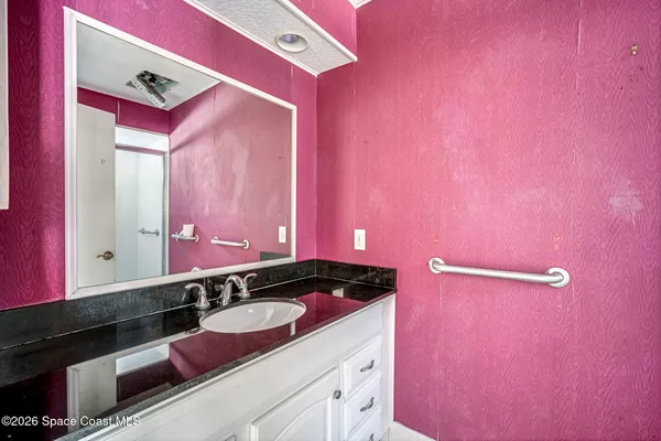 a room with furniture a refrigerator and storage