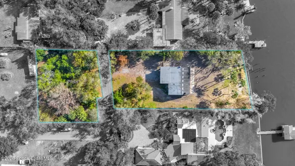 an aerial view of a house with a yard