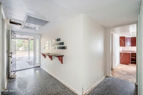 a view of a hallway with bathroom